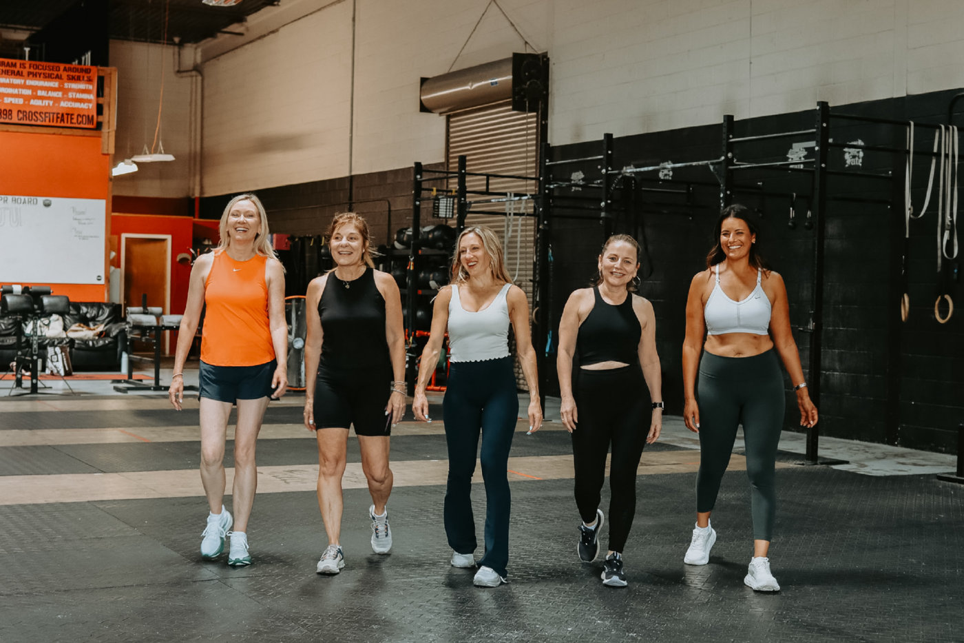 Group class members walking together at the gym